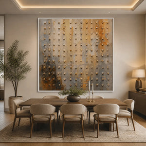 Textured abstract wall art with raised beaded details in neutral beige and gray tones displayed in a refined dining room.