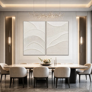 Minimalist textured Wabi Sabi wall art set with two white abstract panels above a dining table