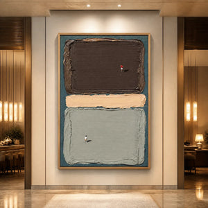 Silent Swimmers abstract wall art with textured color blocks in dark brown, beige, and sage green in a wood frame displayed in a luxury hotel lobby.