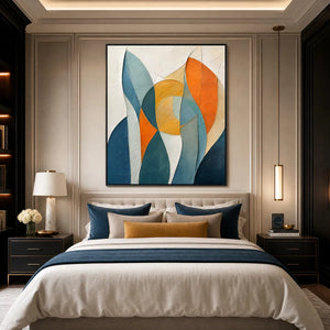 Textured geometric abstract oil painting in blue, teal, orange, and gold above a modern bedroom bed
