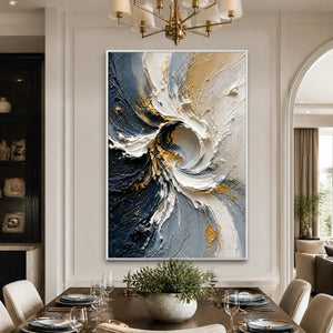 Abstract spiral wall art with white, navy and gold textured palette knife strokes in a white frame displayed in a refined dining room.