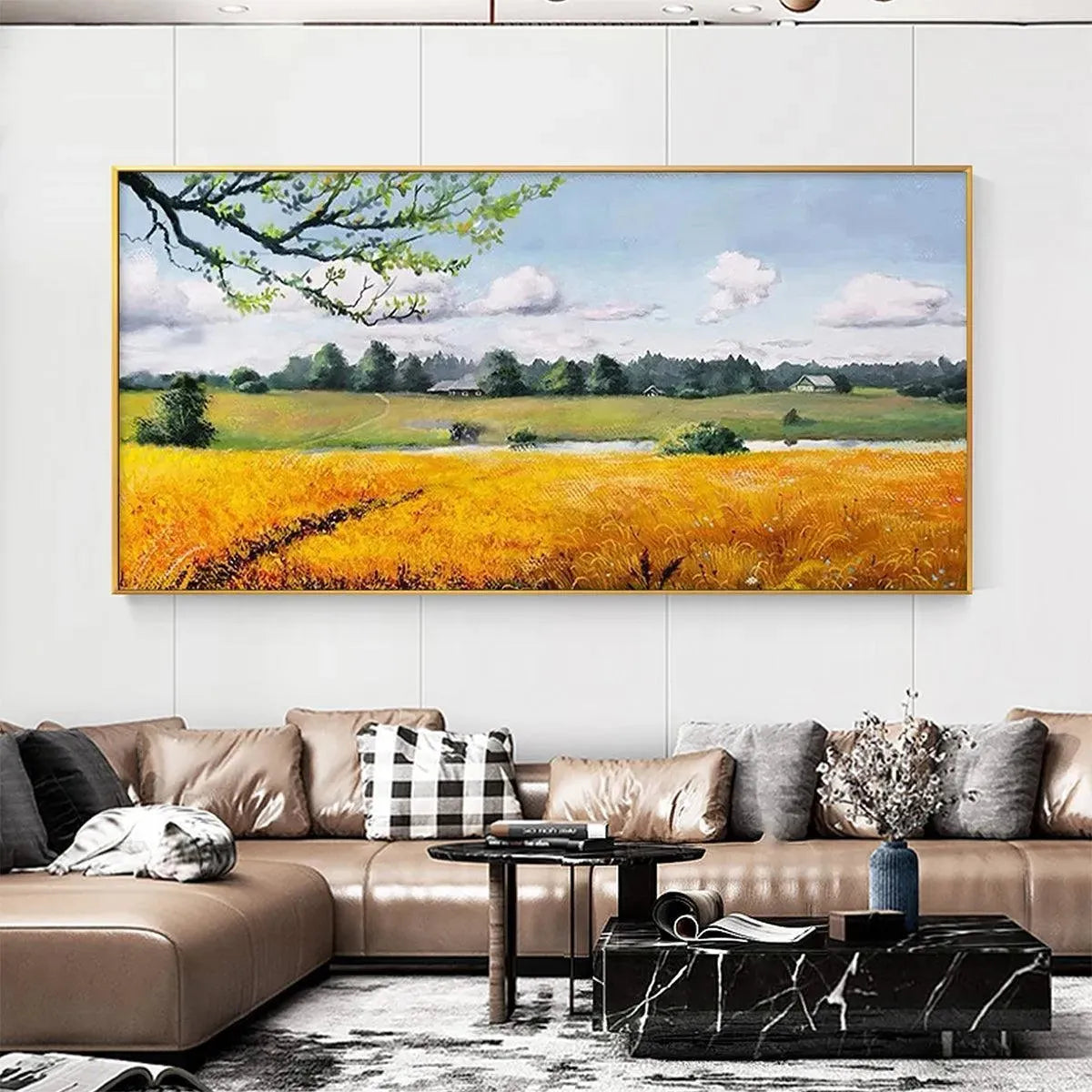 Golden Harvest golden field landscape artwork displayed over a tan leather sectional in a modern living room.