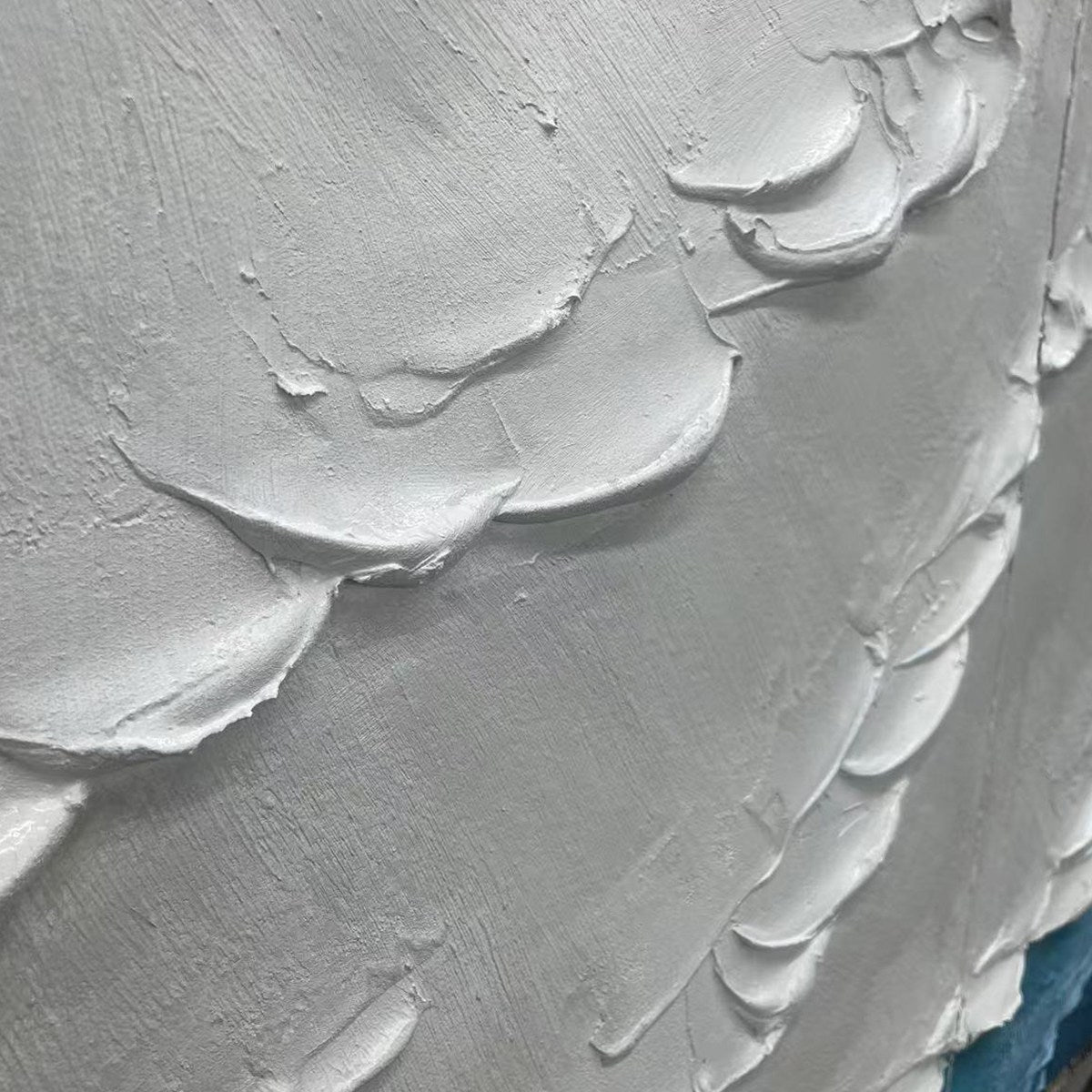 Close-up of textured white abstract painting with thick impasto strokes, showing layered wave-like shapes and coastal detail.