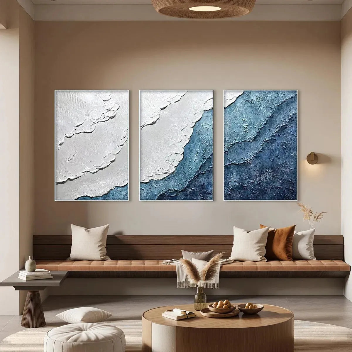 Textured blue & white abstract triptych ocean wave paintings in lifestyle setting.