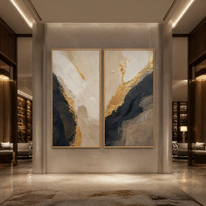 Twin Ember black gold diptych abstract wall art in a wood frame displayed in a luxury hotel lobby.