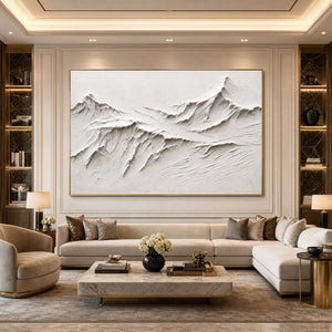 White textured mountain wall art in gold frame above beige sofa