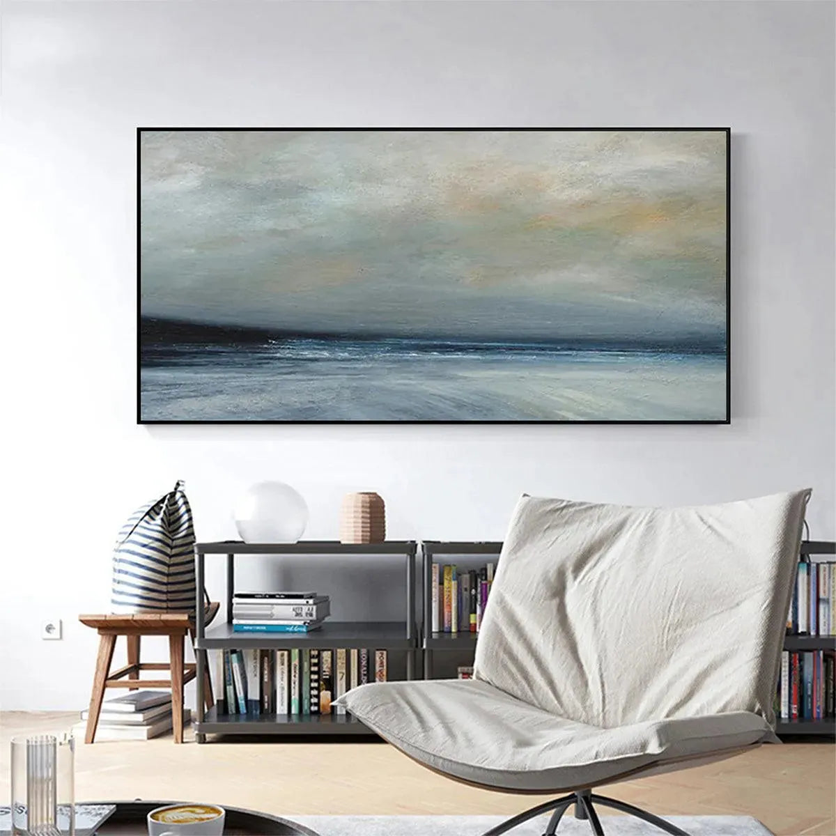 Liam O'Connell's Twilight Coast panoramic painting: muted blues and grays over a dark sea, displayed in a modern living room.
