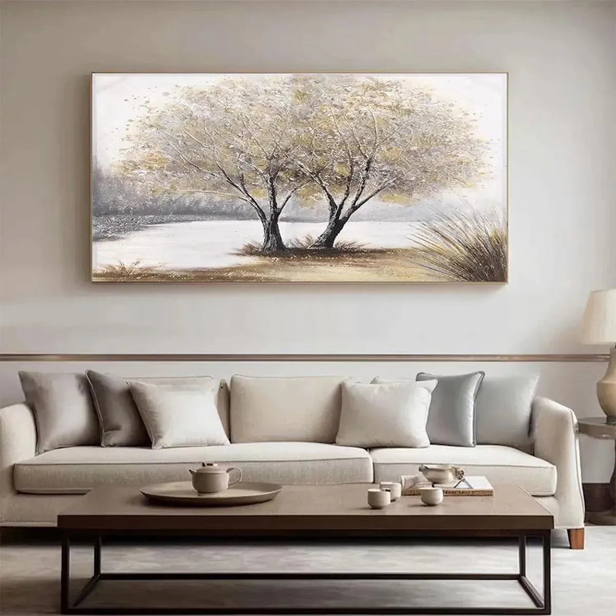 Twilight Trees landscape painting of two trees by water, displayed in modern living room above a neutral sofa.