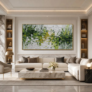 Green and white textured abstract impasto wall art in a gold frame above a modern sofa