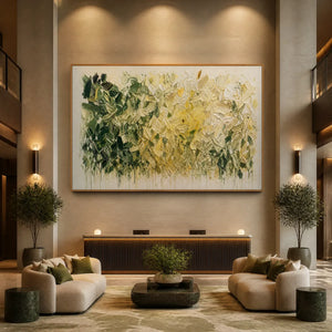 White botanical abstract wall art with green foliage and layered impasto texture in a wood frame displayed in a luxury hotel lobby.