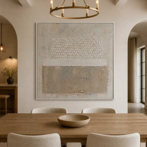 White relief abstract wall art in beige frame displayed in a refined dining room.