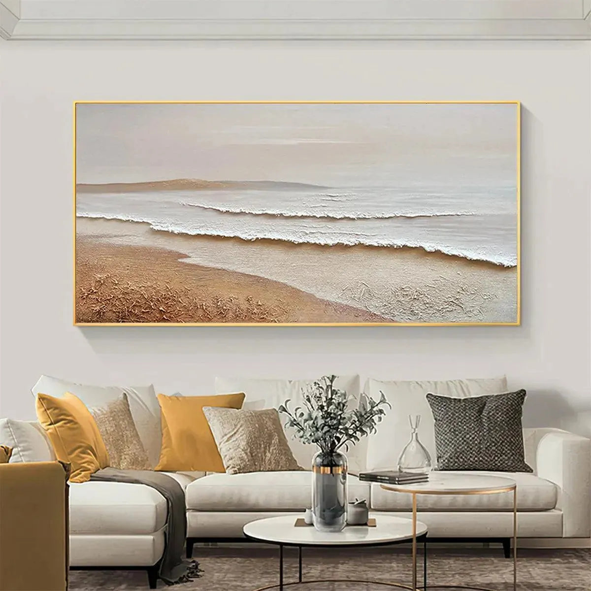Liam O'Connell 'Whispering Tides' textured beach painting in beige and white, framed, above a cream sofa