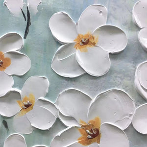 White impasto floral painting detail showing textured blossoms, golden centers, and blue background.