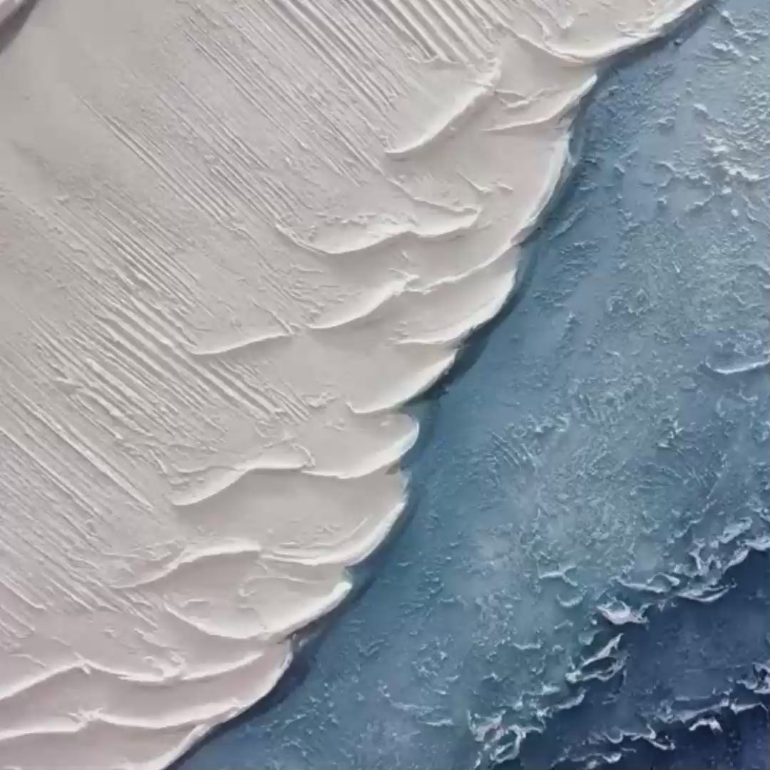 Textured abstract triptych painting set in shades of blue and white, framed in gold, evoking ocean waves.